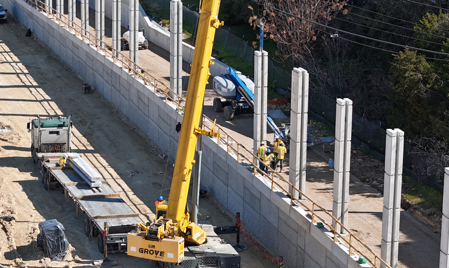 Crews construct sound wall columns. February 2024.