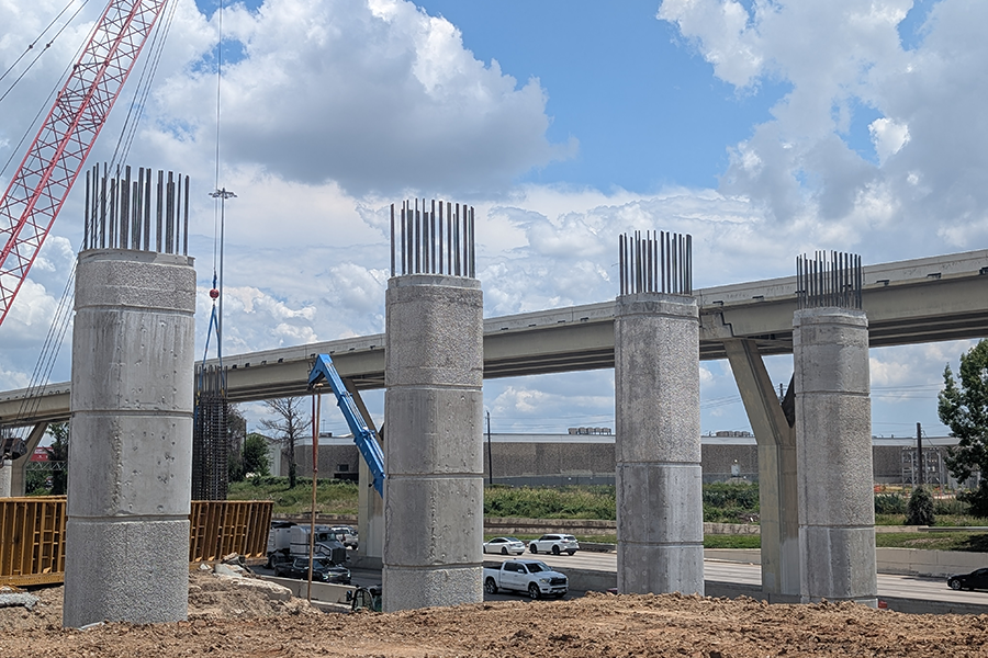 Concrete pillars with steel reinforcement going up for future elevated road construction.