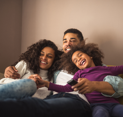 Family smiling on sofa