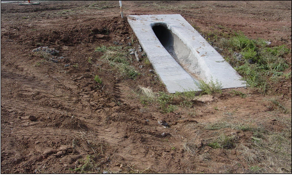 Pipe mitired to conform to fill slope. (click in image to see full-size image)