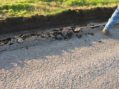 Lateral shear failure at the pavement edge(1st photo). (click in image to see full-size image)