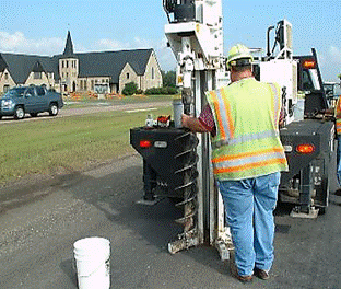 Augering a pavement for material samples. (click in image to see full-size image)