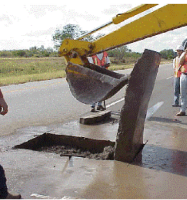 Flipping hot-mix asphalt (HMA) block outwith backhoe. (click in image to see full-size image)