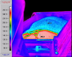 Infrared picture of a truck dumping HMAshowing the cold surface layer crust (blue) and the hot inner mass(red).© Copyright 2006 University of Washington (click in image to see full-size image)