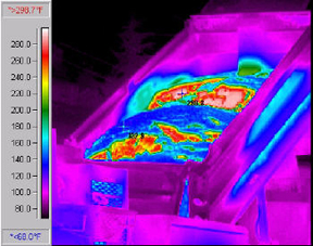Infrared picture of a truck dumping HMAshowing the cold surface layer crust (blue) and the hot inner mass(red).© Copyright 2006 University of Washington (click in image to see full-size image)
