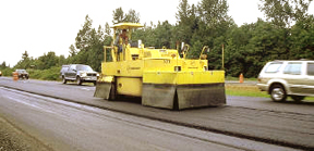 Pneumatic Tire Roller (notice rubber skirtinsulation around tire area as well as tire marks left in the newmat in front of the roller).© Copyright 2006 University of Washington (click in image to see full-size image)