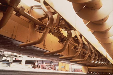Underside of slip-form paver. (click in image to see full-size image)