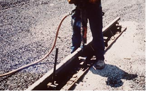 Using jackhammer to set staking pin. (click in image to see full-size image)