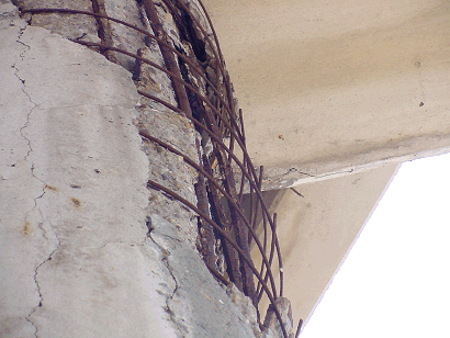 Close up of the damage. Notice the #9 barsare starting to buckle. Two reasons this could be happening: 1.Rust could be pushing on concrete causing the buckling. 2. The column couldbe shortening. This bridge was replaced after 20 years of service. (click in image to see full-size image)