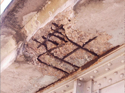 Poorly maintained joint allowed de-icersolution to damage overhang to second mat of steel and top platesteel on beam. (click in image to see full-size image)