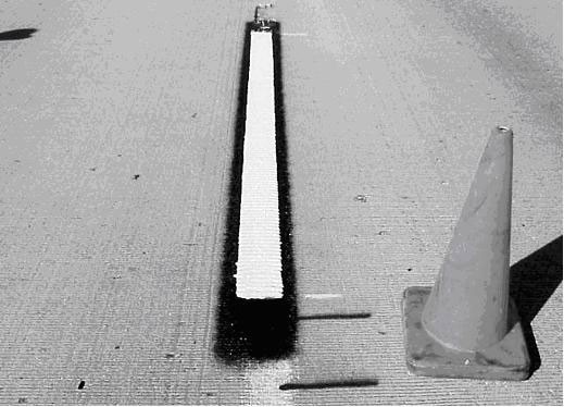 Typical bordered-contrast pavement marking for lane line. (click in image to see full-size image)