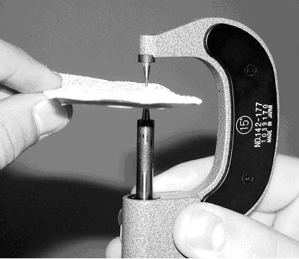 Needlepoint micrometer measuring thermoplastic sample. (click in image to see full-size image)