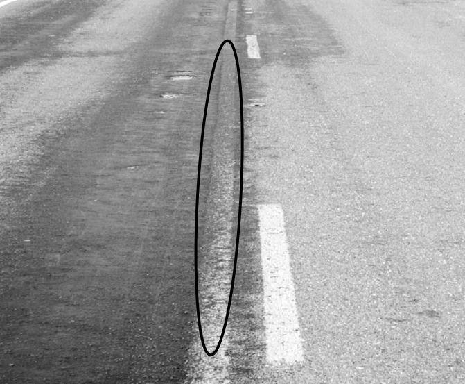 Asphalt tracked onto markings. (click in image to see full-size image)