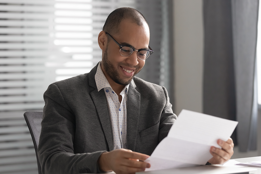 Man reading letter at desk