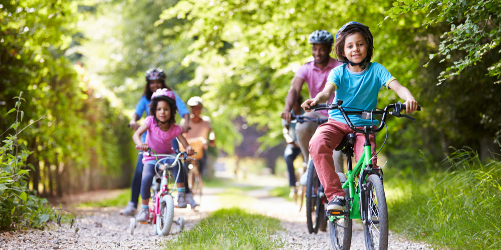 Family riding bicycles on trail