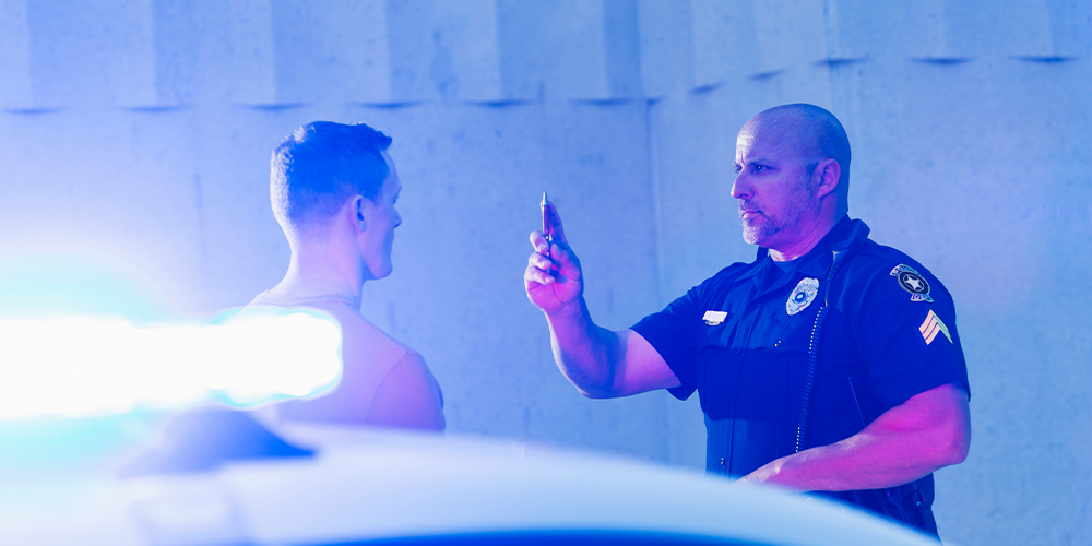 Officer administering DUI test on roadside