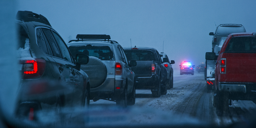 Vehicles on icy road behind police car