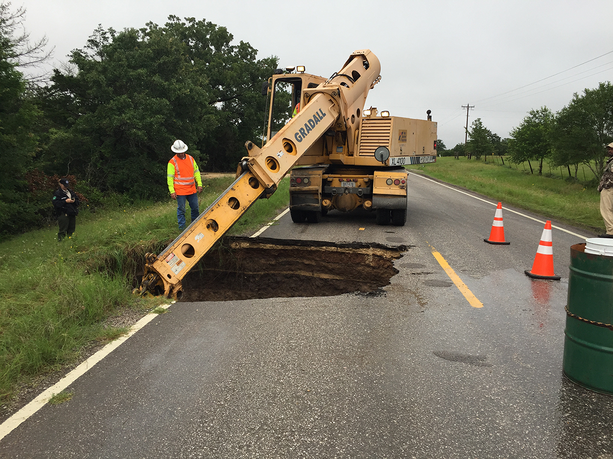 Sink hole in the road being fixed by road crew