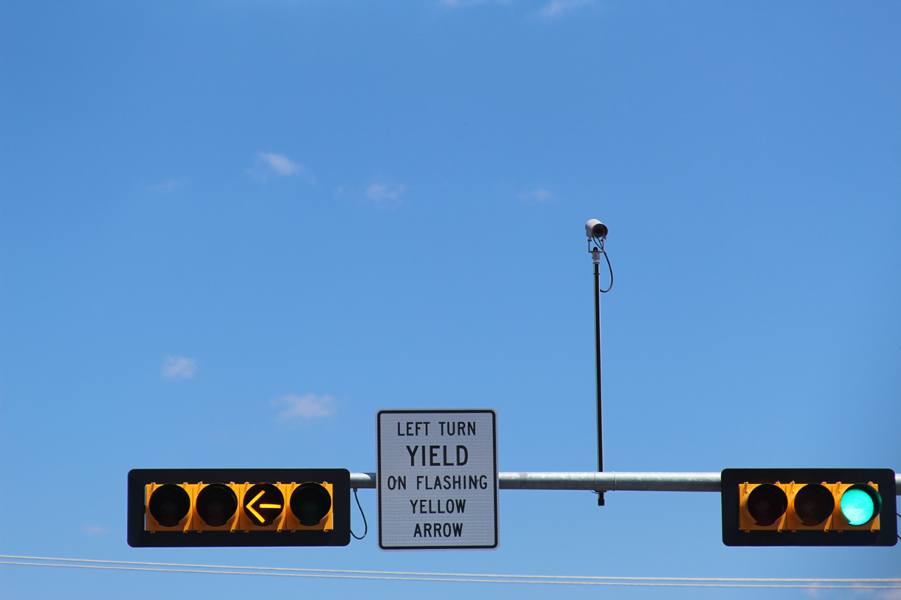 Flashing turn signal for left turn yield on flashing yellow arrow sign